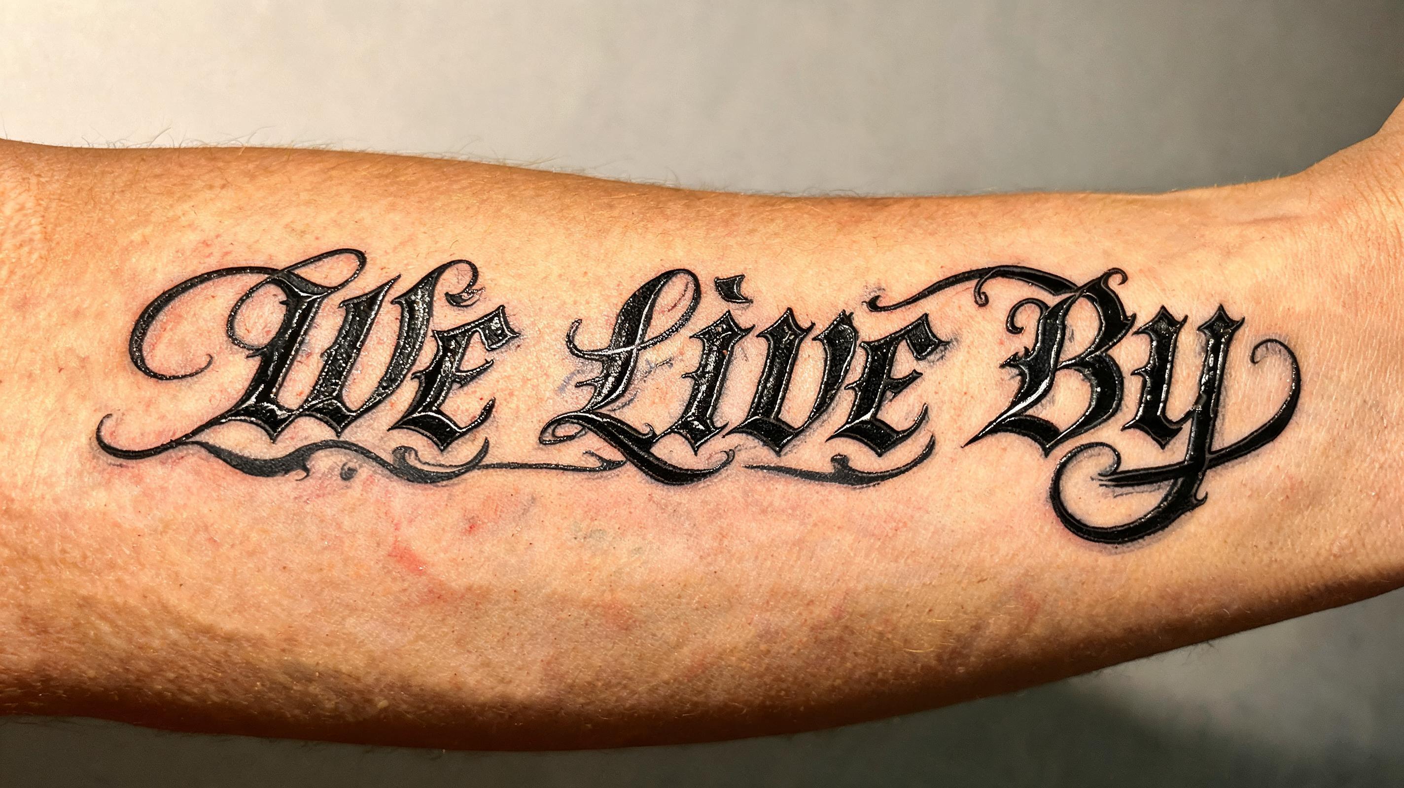 "WE LIVE BY" — Chicano text effect