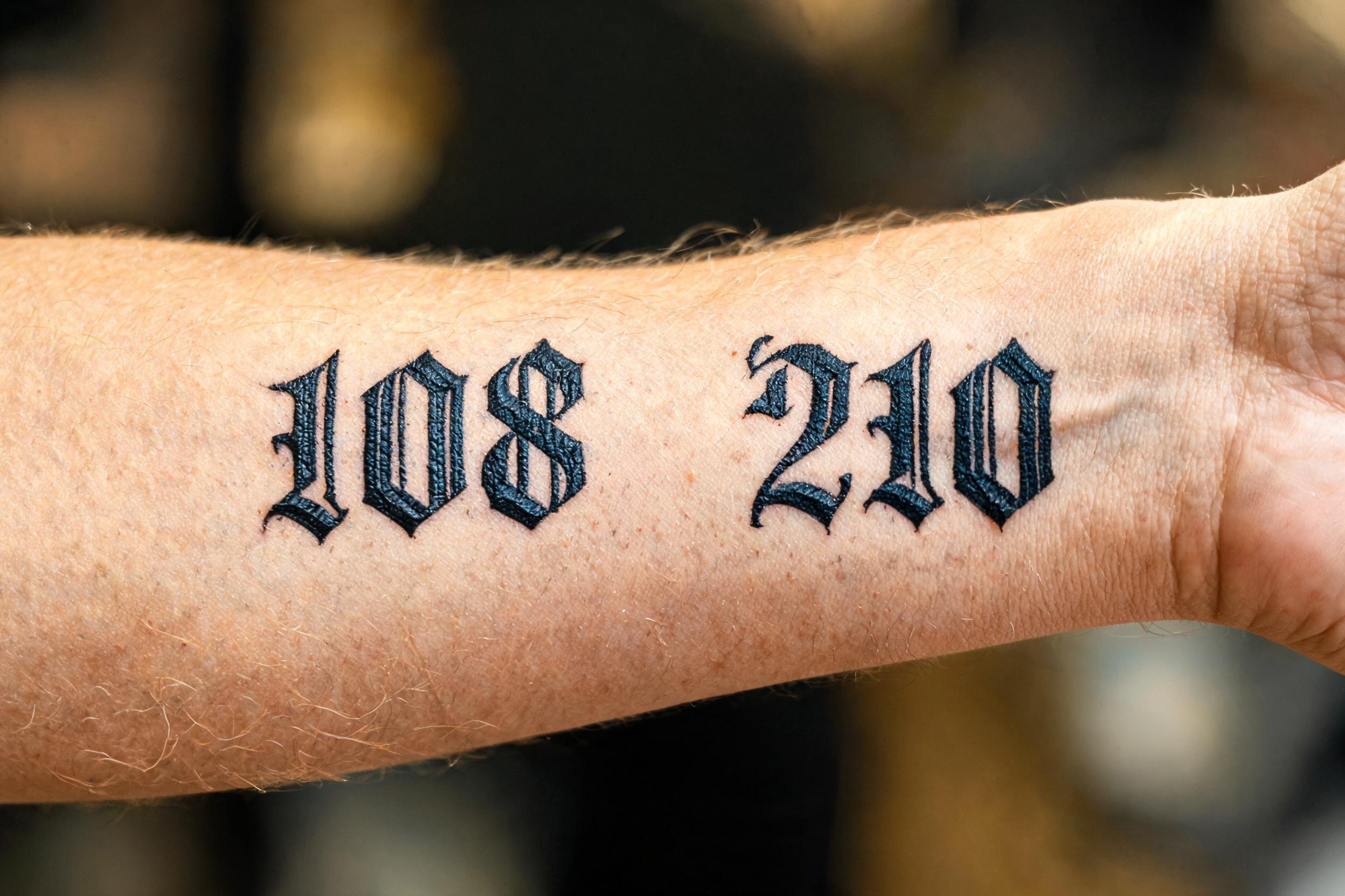 "108 210" — Tattoo | AI Text Effect Generator