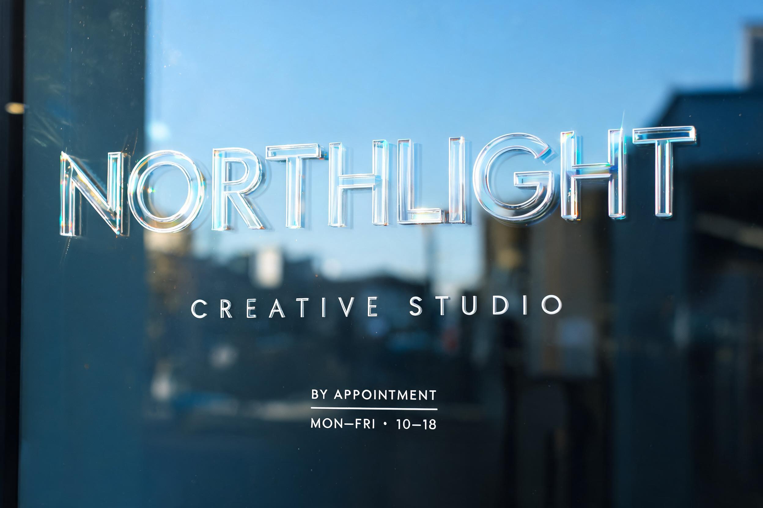 "NORTHLIGHT
CREATIVE STUDIO
BY APPOINTMENT
MON–FRI · 10–18" — Glass Morphism | AI Text Effect Generator