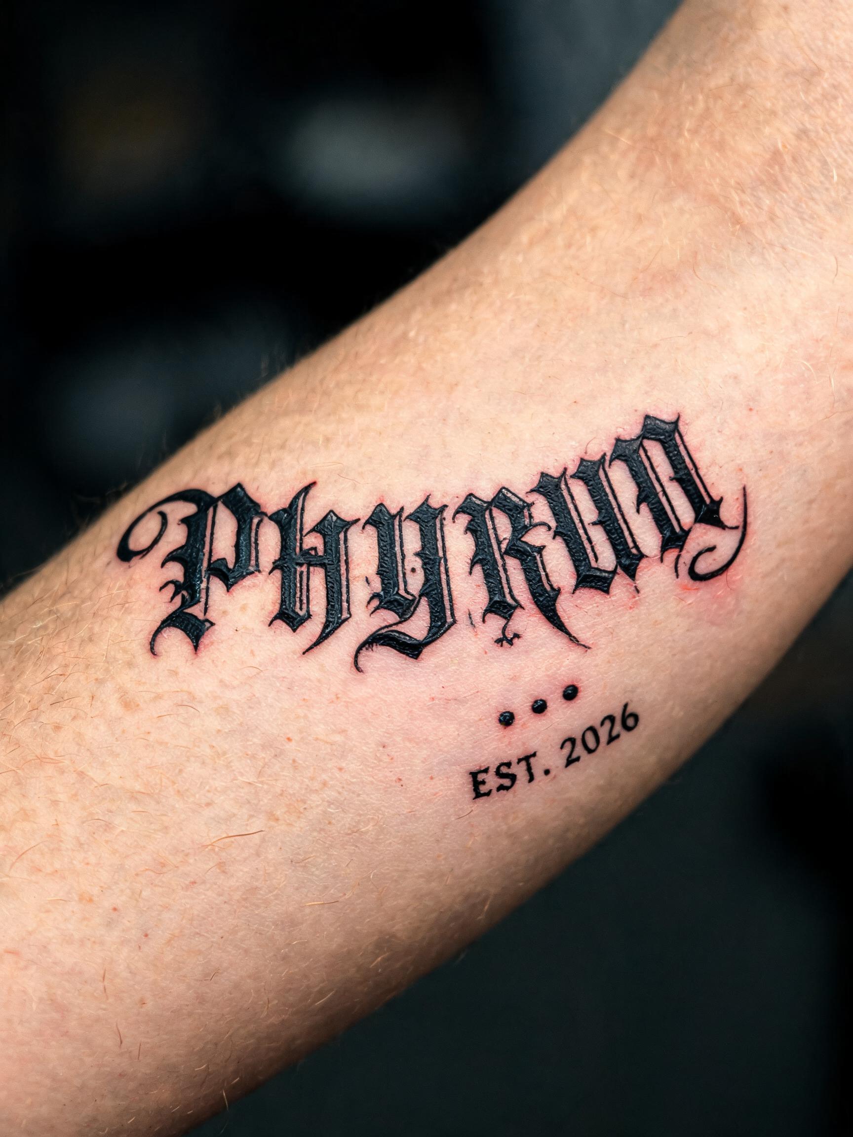 "PHYRUN
EST. 2026" — Tattoo text effect